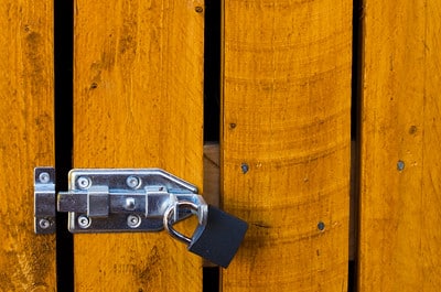 A small outdoor room with slide latches that can be secured with padlocks.