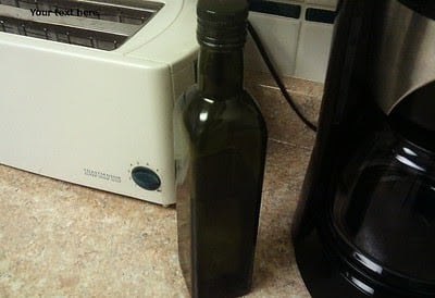 a bottle and kitchen appliances on the counter