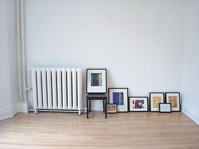 a-white-room-with-dfferent-frames-of-beautiful-paintings